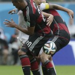 United States' Clint Dempsey is squeezed between Germany's Jerome Boateng, front, and Per Mertesacker during the group G World Cup soccer match between the USA and Germany at the Arena Pernambuco in Recife, Brazil, Thursday, June 26, 2014. (AP Photo/Matthias Schrader)