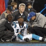 Team members examine injured Carolina Panthers' Philly Brown (16) in the first half of an NFL wild card playoff football game against the Arizona Cardinals in Charlotte, N.C., Saturday, Jan. 3, 2015. (AP Photo/Bob Leverone)