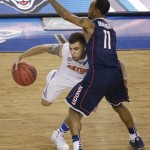 Florida guard Scottie Wilbekin, left, drives around Connecticut guard Ryan Boatright during the first half of the NCAA Final Four tournament college basketball semifinal game Saturday, April 5, 2014, in Arlington, Texas. (AP Photo/Tony Gutierrez)