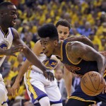 Cleveland Cavaliers guard Iman Shumpert, foreground, drives on Golden State Warriors forward Draymond Green, left, and guard Stephen Curry during the first half of Game 2 of basketball's NBA Finals in Oakland, Calif., Sunday, June 7, 2015. (AP Photo/Ben Margot)
