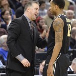 Purdue head coach Matt Painter, left, talks with Vince Edwards during the second half of an NCAA tournament second round college basketball game against Cincinnati in Louisville, Ky., Thursday, March 19, 2015. Cincinnati won in overtime 66-65. (AP Photo/Timothy D. Easley)