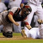 Colorado Rockies' Rafael Ynoa, right, is tagged out by Arizona Diamondbacks catcher Miguel Montero on an attempted inside-the-park home run in the fifth inning of a baseball game Friday, Sept. 19, 2014, in Denver. (AP Photo/Chris Schneider)