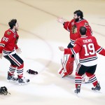 Chicago Blackhawks' goalie Corey Crawford, top, Jonathan Toews (19) and Andrew Shaw (65) celebrate after defeating the Tampa Bay Lightning in Game 6 of the NHL hockey Stanley Cup Final series on Monday, June 15, 2015, in Chicago. The Blackhawks defeated the Lightning 2-0 to win the series 4-2. (AP Photo/Charles Rex Arbogast)
