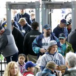 Fans walk through metal detectors as they are screened by security before an opening day baseball game between the Seattle Mariners and the Los Angeles Angels, Monday, April 6, 2015, in Seattle. (AP Photo/Ted S. Warren)