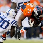 Denver Broncos running back C.J. Anderson (22) is tackled by Indianapolis Colts free safety Darius Butler (20) during the first half of an NFL football game, Sunday, Sept. 7, 2014, in Denver. (AP Photo/Joe Mahoney)