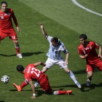Argentina's Lionel Messi tries to control the ball surrounded by Iran's defender Andranik Teymourian, top left, Mehrdad Pouladi, left, and Ehsan Hajsafi, right, during the group F World Cup soccer match between Argentina and Iran at the Mineirao Stadium in Belo Horizonte, Brazil, Saturday, June 21, 2014. (AP Photo/Sergei Grits)