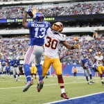 New York Giants wide receiver Odell Beckham Jr. (13) makes a catch for a touchdown against Washington Redskins free safety E.J. Biggers (30) during the first quarter of an NFL football game, Sunday, Dec. 14, 2014, in East Rutherford, N.J. (AP Photo/Julio Cortez)