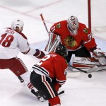 Chicago Blackhawks goalie Antti Raanta (31) makes a save on a shot by Arizona Coyotes right wing David Moss (18) as Duncan Keith (2) also defends during the first period of an NHL hockey game Monday, Feb. 9, 2015, in Chicago. (AP Photo/Charles Rex Arbogast)