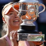Russia's Maria Sharapova holds the trophy after winning the final of the French Open tennis tournament against Romania's Simona Halep at the Roland Garros stadium, in Paris, France, Saturday, June 7, 2014. Sharapova won in three sets 6-4, 6-7, 6-4. (AP Photo/Darko Vojinovic)