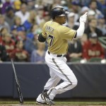 Milwaukee Brewers' Carlos Gomez hits a single against the Arizona Diamondbacks during the first inning of a baseball game Saturday, May 30, 2015, in Milwaukee. (AP Photo/Jeffrey Phelps)