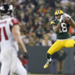 Green Bay Packers' Randall Cobb goes up for a pass against Atlanta Falcons' Kroy Biermann (71) during the second half of an NFL football game Monday, Dec. 8, 2014, in Green Bay, Wis. (AP Photo/Mike Roemer)