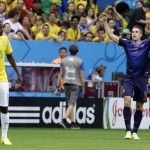 Netherlands' Robin van Persie, right, celebrates after scoring the opening goal during the World Cup third-place soccer match between Brazil and the Netherlands at the Estadio Nacional in Brasilia, Brazil, Saturday, July 12, 2014. (AP Photo/Hassan Ammar)