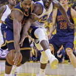Cleveland Cavaliers center Tristan Thompson, left, and Golden State Warriors forward Draymond Green reach for the ball during the first half of Game 5 of basketball's NBA Finals in Oakland, Calif., Sunday, June 14, 2015. (AP Photo/Ben Margot)
