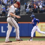 Arizona Diamondbacks pitcher Chase Anderson, left, reacts as New York Mets' Michael Cuddyer rounds the bases after hitting a solo home run during the first inning of a baseball game Friday, July 10, 2015, in New York. (AP Photo/Bill Kostroun)

