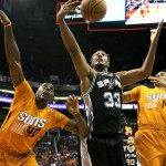 San Antonio Spurs forward Boris Diaw (33) battles with Phoenix Suns forward Anthony Tolliver (40), left, and Gerald Green (14) for the ball in the first quarter during an NBA basketball game, Friday, Oct. 31, 2014, in Phoenix. (AP Photo/Rick Scuteri)