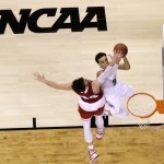 Duke's Tyus Jones drives to the basket over Wisconsin's Frank Kaminsky, left, during the first half of the NCAA Final Four college basketball tournament championship game Monday, April 6, 2015, in Indianapolis. (AP Photo/Michael Conroy)