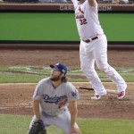 St. Louis Cardinals first baseman Matt Adams (32) reacts in front of Los Angeles Dodgers starting pitcher Clayton Kershaw after hitting a three-run home run in the seventh inning of Game 4 of baseball's NL Division Series Tuesday, Oct. 7, 2014, in St. Louis. (AP Photo/Tom Gannam)