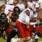 Utah's Travis Wilson (7) gets past Arizona State's Viliami Latu, left, as he runs with the football in the first half of an NCAA college football game on Saturday, Nov. 1, 2014, in Tempe, Ariz. (Photo/Ross D. Franklin)