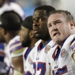 Buffalo Bills defensive tackle Kyle Williams, foreground, looks up from the bench during the second half of an NFL football game against the Miami Dolphins, Thursday, Nov. 13, 2014 in Miami Gardens, Fla. (AP Photo/Alan Diaz)