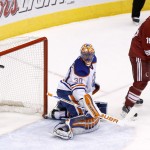  Edmonton Oilers goalie Ben Scrivens (30) gives up a goal to Phoenix Coyotes' Oliver Ekman-Larsson, not seen, as Coyotes' Shane Doan (19) watches during the second period of an NHL hockey game, Friday, April 4, 2014, in Glendale, Ariz. (AP Photo/Ross D. Franklin)