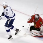 Tampa Bay Lightning's Alex Killorn, left, tries to spin around Chicago Blackhawks goalie Corey Crawford keeps his eye on a loose puck during the first period in Game 6 of the NHL hockey Stanley Cup Final series on Monday, June 15, 2015, in Chicago. (AP Photo/Charles Rex Arbogast)