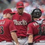 Arizona Diamondbacks manager Chip Hale (3) and catcher Jordan Pacheco (31) confer with relief pitcher Randall Delgado after he loaded the bases in the seventh inning of a baseball game against the Philadelphia Phillies, Sunday, May 17, 2015, in Philadelphia. The Phillies won 6-0. (AP Photo/Laurence Kesterson)