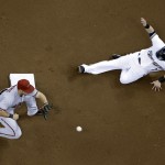  Milwaukee Brewers' Scooter Gennett steals second with Arizona Diamondbacks shortstop Chris Owings covering during the first inning of a baseball game Tuesday, May 6, 2014, in Milwaukee. (AP Photo/Morry Gash)