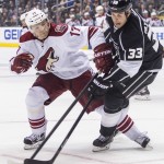  Los Angeles Kings defenseman Willie Mitchell (33) and Phoenix Coyotes forward Radim Vrbate (17), of the Czech Republic, vie for the puck during the first period of an NHL hockey game, Wednesday, April 2, 2014, in Los Angeles. (AP Photo/Ringo H.W. Chiu)