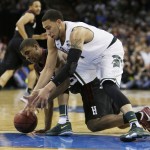  Michigan State's Denzel Valentine, right, and Harvard's Wesley Saunders go after a loose ball in the second half during the third-round game of the NCAA men's college basketball tournament in Spokane, Wash., Saturday, March 22, 2014. (AP Photo/Young Kwak)