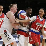 Kevin Hart, center, and Michael Rapaport, left, defend Mo'ne Davis, right, during the first half of the NBA All-Star celebrity basketball game Friday, Feb. 13, 2015, in New York. (AP Photo/Frank Franklin II)