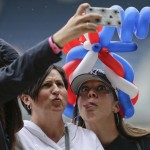 Kimberly O'Kane, right, of Stony Point, N.Y., poses for a selfie with her aunt, Catherine O'Kane of Springfield, Penn., center, and cousin Corinne O'Kane, of Hoboken, N.J., while attending a baseball game between the Tampa Bay Rays and the New York Yankees, Saturday, July 4, 2015, in New York. (AP Photo/Julie Jacobson)
