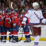 The Washington Capitals celebrate around center Jay Beagle (83) after his goal during the second period of Game 3 in the second round of the NHL Stanley Cup hockey playoffs against the New York Rangers, Monday, May 4, 2015, in Washington. (AP Photo/Alex Brandon)