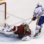  Edmonton Oilers' Sam Gagner, right, scores against Phoenix Coyotes' Thomas Greiss, of Germany, during the shootout of an NHL hockey game, Friday, April 4, 2014, in Glendale, Ariz. The Oilers won 3-2. (AP Photo/Ross D. Franklin)