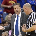 Kentucky head coach John Calipari, left, argues a call with a game official during the second half of an NCAA tournament college basketball game in Louisville, Ky., Saturday, March 21, 2015. (AP Photo/Timothy D. Easley)