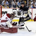 Arizona Coyotes goalie Mike Smith (41) stops a shot by Pittsburgh Penguins' Sidney Crosby (87) with Michael Stone (26) defending during the second period of an NHL hockey game in Pittsburgh Saturday, March 28, 2015. (AP Photo/Gene J. Puskar)

