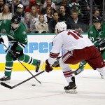 Dallas Stars' left wing Erik Cole (72) shoots as Arizona Coyotes' right wing David Moss (18 defends and Stars' right wing Ales Hemsky (83), of the Czech Republic, watches in the first period of an NHL hockey game Wednesday, Dec. 31, 2014, in Dallas. (AP Photo/Sharon Ellman)