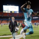 Miami Dolphins wide receiver Jarvis Landry (14) leaps as he leaves the field after the Dolphins' NFL football game against the Buffalo Bills, Thursday, Nov. 13, 2014, in Miami Gardens, Fla. The Dolphins defeated the Bills 22-9. (AP Photo/Lynne Sladky)