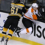 Boston Bruins left wing Craig Cunningham (61) checks Philadelphia Flyers defenseman Andrew MacDonald (47) into the boards in the first period of an NHL hockey game in Boston, Wednesday, Oct. 8, 2014. (AP Photo/Elise Amendola)