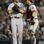 Arizona Diamondbacks catcher Miguel Montero, right, talks with starting pitcher Chase Anderson in the fourth inning of a baseball game against the Colorado Rockies, Friday, Sept. 19, 2014, in Denver. (AP Photo/Chris Schneider)