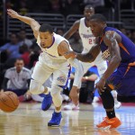 Los Angeles Clippers guard Jared Cunningham, left, and Phoenix Suns guard Eric Bledsoe go after a loose during the first half of a preseason NBA basketball game, Wednesday, Oct. 22, 2014, in Los Angeles. (AP Photo/Mark J. Terrill)