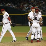 Arizona Diamondbacks' Trevor Cahill, left, leaves the game as interim manager Alan Trammell, second from left, talks with players, including Miguel Montero (26), Mark Trumbo (15) and Didi Gregorius, third from right, during the sixth inning of a baseball game against the St. Louis Cardinals on Friday, Sept. 26, 2014, in Phoenix. (AP Photo/Ross D. Franklin)
