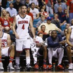 Arizona's T.J. McConnell (4) and his teammates cheer in the second half of an NCAA college basketball game against California in the quarterfinals of the Pac-12 conference tournament Thursday, March 12, 2015, in Las Vegas. Arizona won 73-51. (AP Photo/John Locher)
