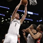 Brooklyn Nets' Mason Plumlee (1) drives past teammate Joe Johnson (7) and Toronto Raptors Kyle Lowry, right, during the second half of Game 3 of an NBA basketball first-round playoff series Friday, April 25, 2014, in New York. The Nets won 102-98. (AP Photo/Frank Franklin II)