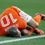 Netherlands' Wesley Sneijder holds his leg after a foul during the World Cup semifinal soccer match between the Netherlands and Argentina at the Itaquerao Stadium in Sao Paulo, Brazil, Wednesday, July 9, 2014. (AP Photo/Frank Augstein)