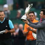 Rory McIlroy of Northern Ireland holds up the Claret Jug trophy after winning the British Open Golf championship as runners up Sergio Garcia of Spain, left, and Rickie Fowler of the US look on at the Royal Liverpool golf club, Hoylake, England, Sunday July 20, 2014. (AP Photo/Scott Heppell)