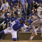  San Francisco Giants' Buster Posey is tagged out by Kansas City Royals catcher Salvador Perez during the first inning of Game 1 of baseball's World Series Tuesday, Oct. 21, 2014, in Kansas City, Mo. Posey tried to score from second on a hit by Pablo Sandoval.(AP Photo/Charlie Neibergall)