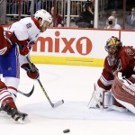 Arizona Coyotes' Mike Smith, right, makes a save on a shot by Montreal Canadiens' Brandon Prust (8) as Coyotes' Connor Murphy (5) defends during the first period of an NHL hockey game Saturday, March 7, 2015, in Glendale, Ariz. (AP Photo/Ross D. Franklin)
