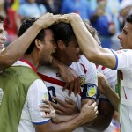  Costa Rica's Bryan Ruiz, center, is congratulated by teammates after scoring his side's first goal over Italy's goalkeeper Gianluigi Buffon during the group D World Cup soccer match between Italy and Costa Rica at the Arena Pernambuco in Recife, Brazil, Friday, June 20, 2014. (AP Photo/Ricardo Mazalan)