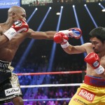 Floyd Mayweather Jr., left, squares off against Manny Pacquiao, from the Philippines, during their welterweight title fight on Saturday, May 2, 2015 in Las Vegas. (AP Photo/John Locher)