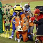 Mascots sing "Happy Birthday" to Miami Marlins mascot Billy the Marlin, center, during a baseball game between the Marlins and the Arizona Diamondbacks, Sunday, Aug. 17, 2014, in Miami. (AP Photo/Lynne Sladky)